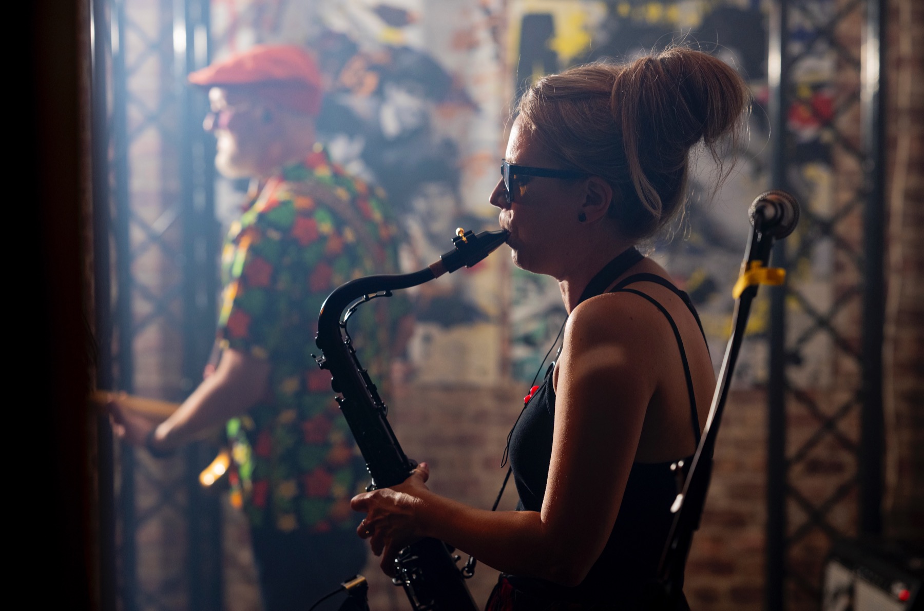Saxophonist performing under festival lighting