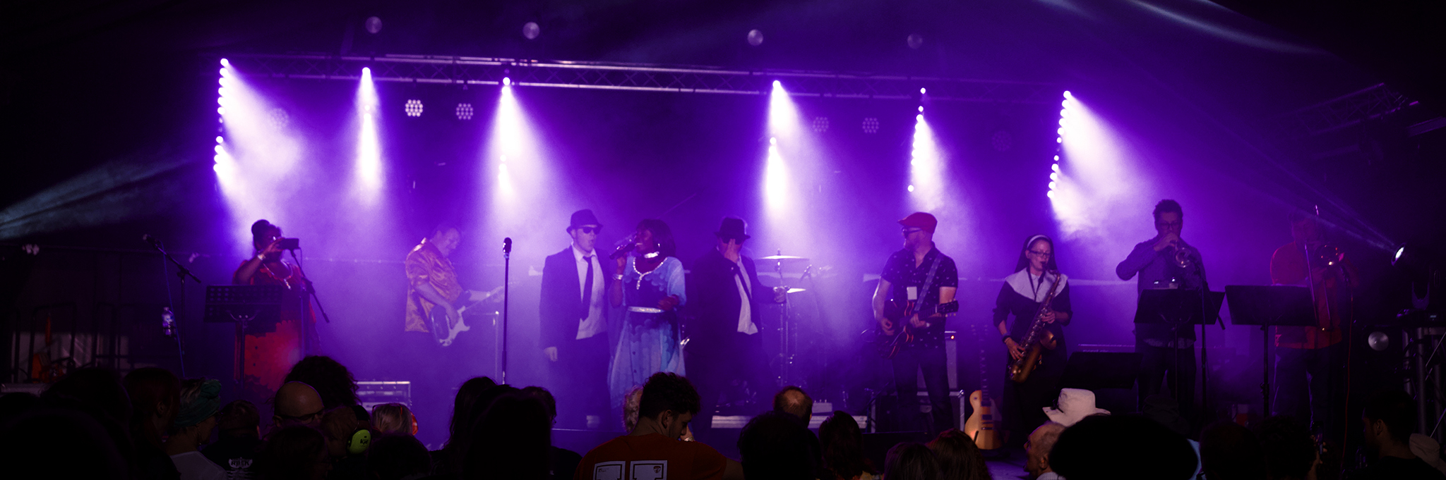 The 11-piece band performing under festival lights at Cambridge Rock Festival