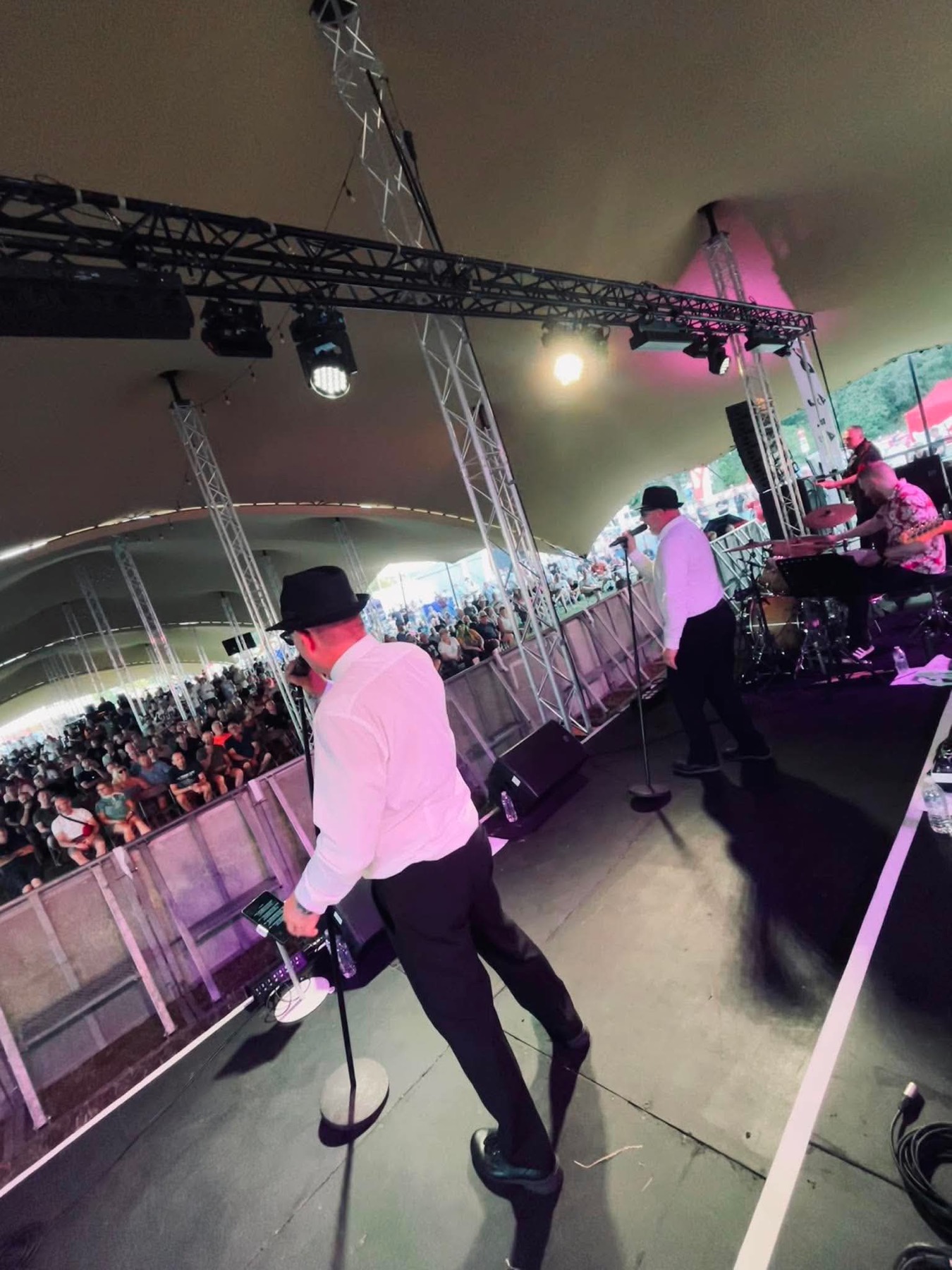 View from the festival stage across the singers towards a large crowd