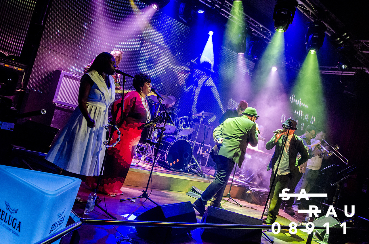 The full band performing under colourful stage lights at Sarau in Badalona, Barcelona