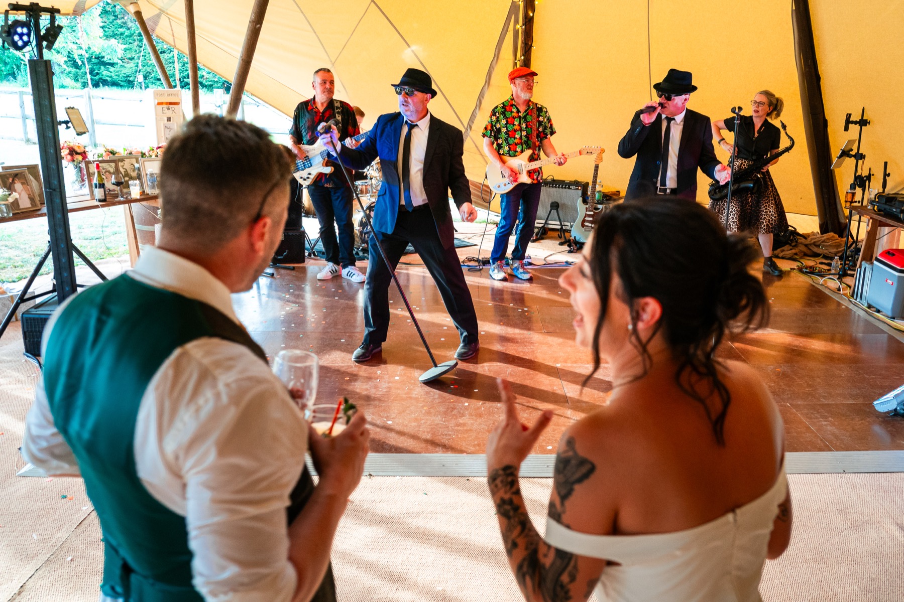 Bride and groom watching The All New Blues and Soul Revue perform at their wedding